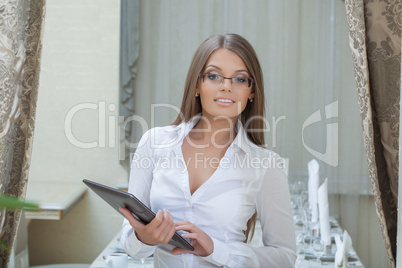 Beautiful business woman posing with tablet PC