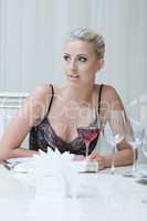 Expressive young blonde posing in restaurant