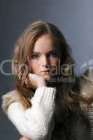 Portrait of young charming girl posing in studio