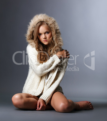 Beautiful girl posing in woolen jacket with hood