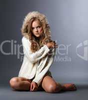 Beautiful girl posing in woolen jacket with hood