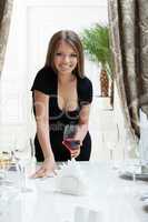 Cute smiling girl posing with glass of red wine