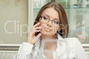 Portrait of thoughtful charming woman in glasses
