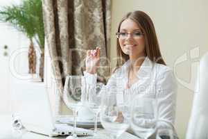 Cheerful business woman works on PC at her lunch