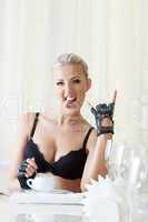 Funny attractive blonde grimacing at table