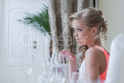 Image of young cute girl posing with wine glasses