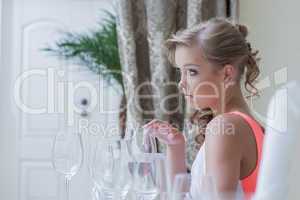 Image of young cute girl posing with wine glasses