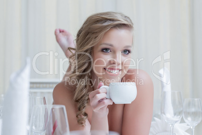 Lovely young woman posing with cup of coffee