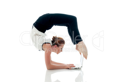 Businesswoman doing yoga and typing on netbook