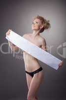 Merry slender girl covers her nudity with tape