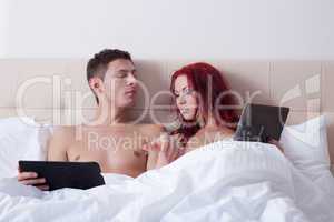 Attractive young partners posing with tablets PC