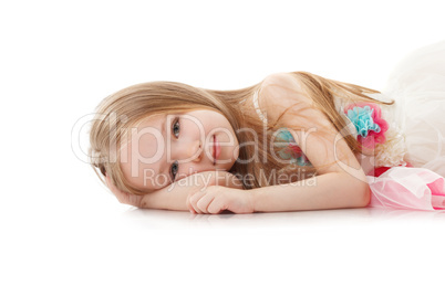 Portrait of smiling adorable girl lying in studio