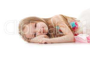 Portrait of smiling adorable girl lying in studio