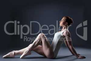 Image of sensual ballet dancer sitting in studio