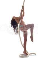 Graceful topless brunette hanging on rope