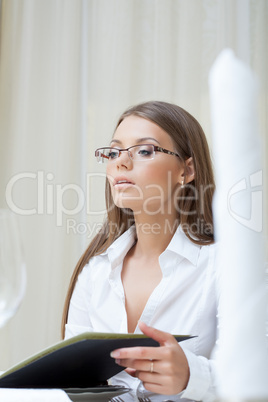 Attractive businesswoman posing in restaurant