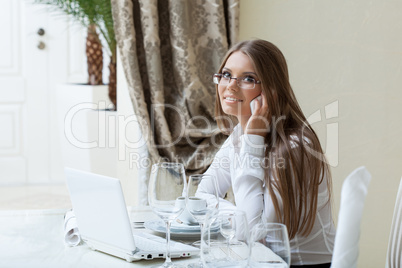 Smiling business lady talking on cell phone