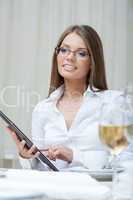 Smiling business woman working on PC tablet