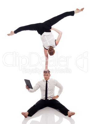 Businessmen-acrobats posing with laptop in studio