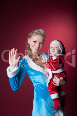 Happy mom-Snow Maiden holds baby-Santa Claus