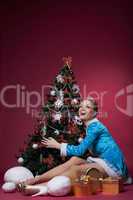 Happy Snow Maiden posing with Christmas tree