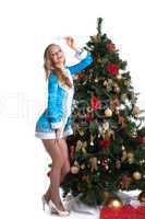 Graceful Snow Maiden posing with decorated fir