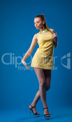 Graceful girl posing with disco makeup in studio