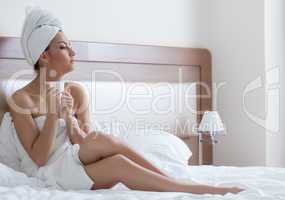 Beautiful young woman drinks coffee after shower