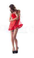 Pretty slender woman posing in red erotic negligee