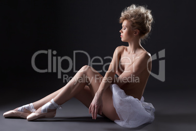 Charming young ballerina posing topless in studio