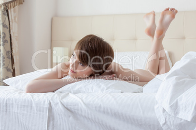 Portrait of charming brunette dreaming in bed