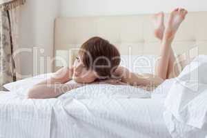 Portrait of charming brunette dreaming in bed