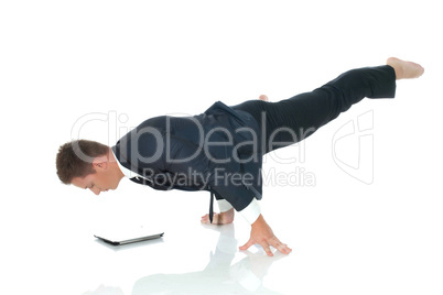 Young busy man posing with laptop in unreal pose