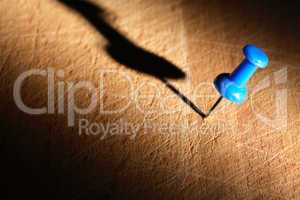 blue pushpin on wood