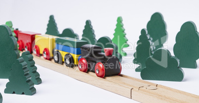 wooden toy train in rural landscape