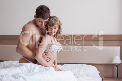 Couple of sensual young lovers posing in bed