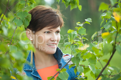 Portrait of cute young brunette posing outdoor