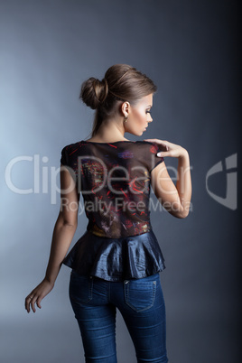 Young fashionable girl posing back to camera