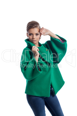 Pretty young model posing in green coat, close-up