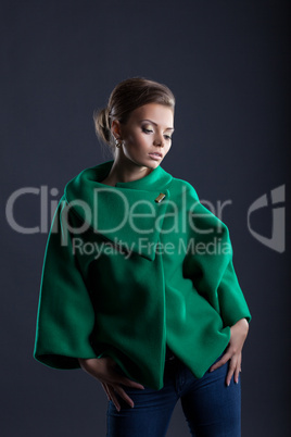 Lovely girl posing in trendy green coat, close-up