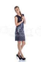 Pretty slim woman posing in trendy cocktail dress