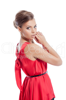 Elegant young woman posing in cocktail dress