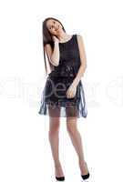 Cheerful girl with long hair posing in black dress