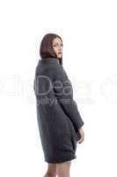 Charming young woman posing in gray woolen coat