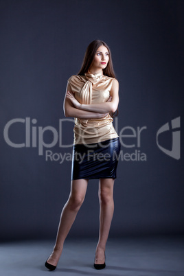 Young stylishly dressed woman posing in studio