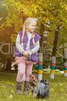 Cute little girl walking with Yorkshire Terrier