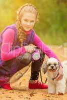 Portrait of adorable little girl posing with ??dog