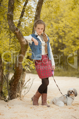 Image of pretty little model posing with dog