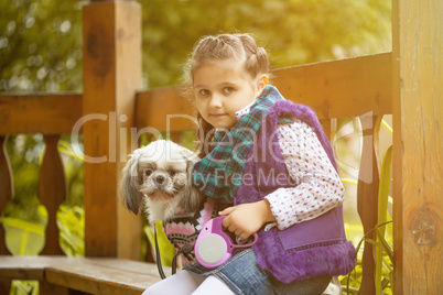 Image of pretty little girl posing with cute dog