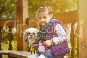 Image of pretty little girl posing with cute dog